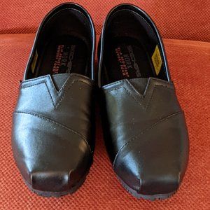 Black Skechers slip resistant flats pillow arch